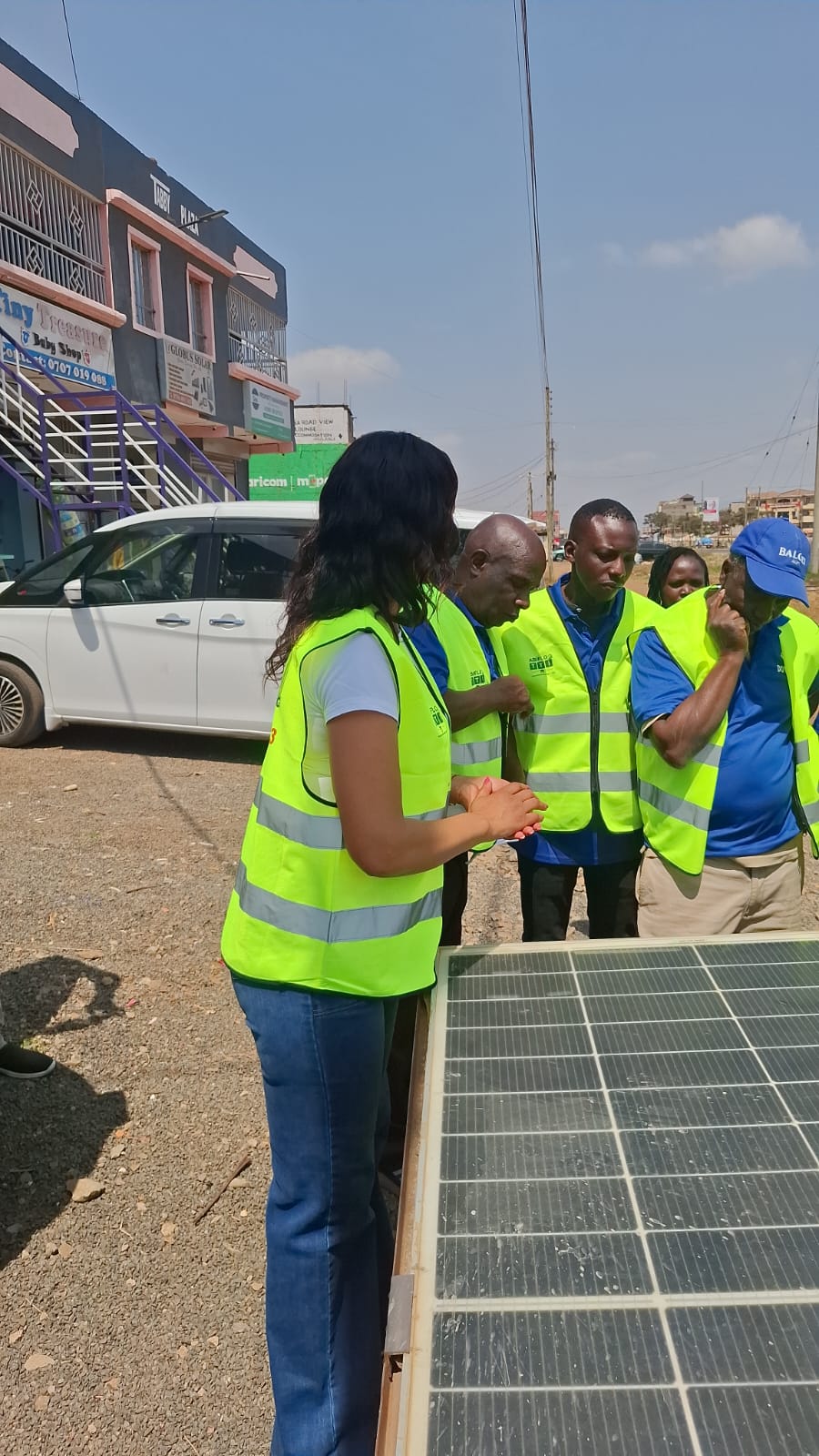 Trainees inspecting a solar panel during a practical session